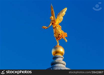 Golden statue on the dome of the Academy of Arts in Dresden.. Dresden. Academy of Arts.