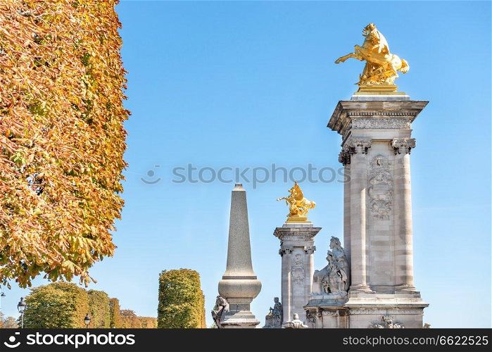 Golden statues on Alexandre III bridge near Les Invalides in Paris, France