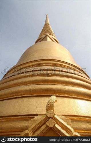 Golden stupa and statue lion in wat Bowonniwet, Bangkok, Thailand