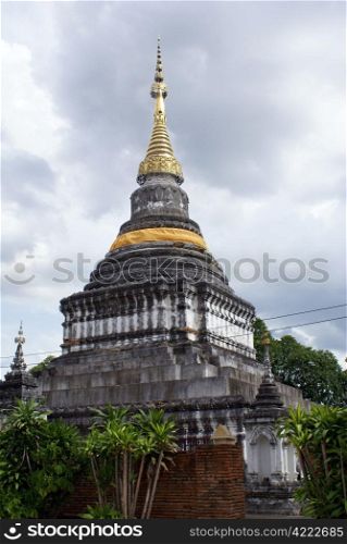 Golden stupa in at Phra Kaew Don Tao in Lampang, Thailand