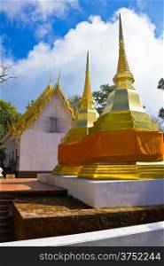 Golden stupa with blue sky at Pra Tad Doi Tung temple, Northern Thailand.
