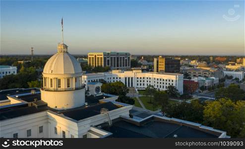 Golden sunlight reaches the horizon showing around the capital statehouse in Montgomery Alabama