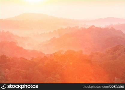 Golden sunrise shines down around the mountain and top canopy. Fantastic light in spring season. Scenic landscape of tropical forest. Nam Nao National Park, Thailand.