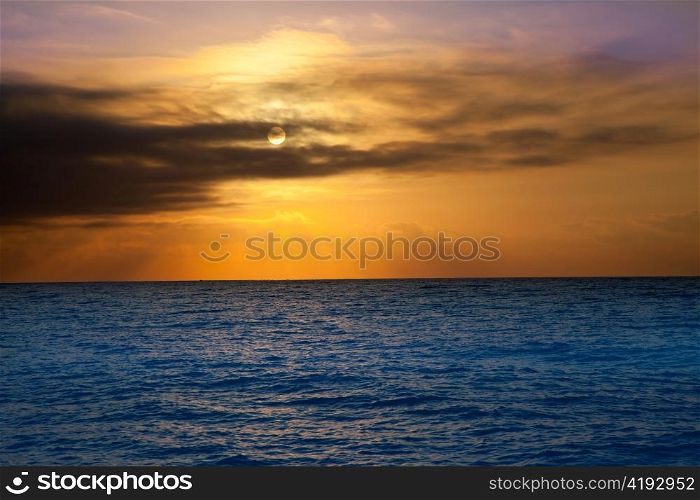golden sunrise with sun and clouds over blue Mediterranean sea