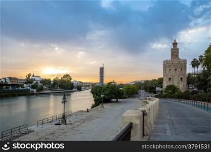Golden Tower with cityscape and river of Sevilla sunset Seville, Spain