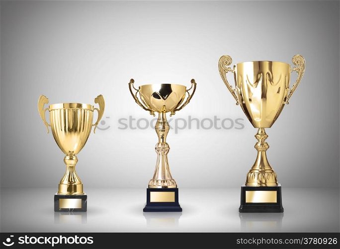 golden trophies on gray background