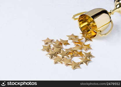 Golden trophy cup with golden stars on white textured background