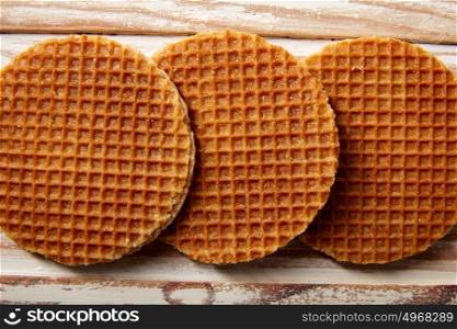Golden Waffle wafer biscuits in a row on wood board