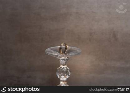 Golden wedding rings isolated on grey background. Romeo and Juliet. Golden wedding ring Romeo and Juliet