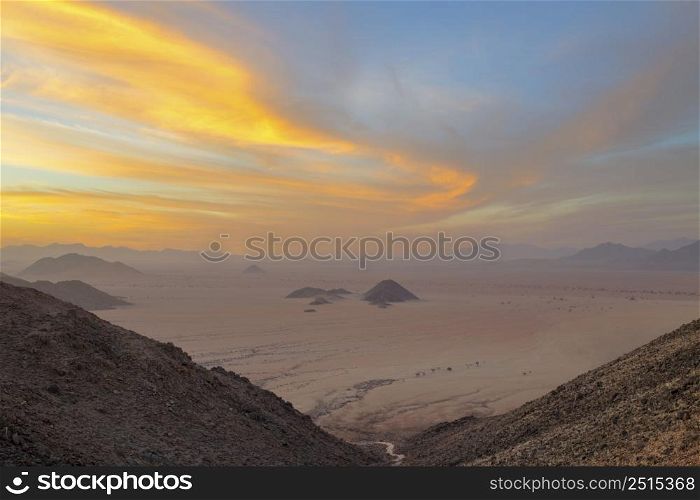 Golden wind swept clouds at sunset Namibia