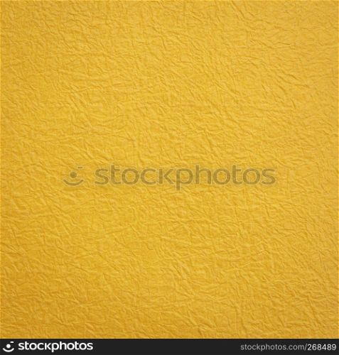 golden yellow Japanese Momi Washi paper background featuring a rough, evenly textured surface formed by crinkling the paper during the manufacturing process