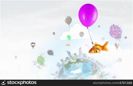 Goldfish fly on balloon. Flying in sky goldfish tied up to big balloon. Elements of this image are furnished by NASA