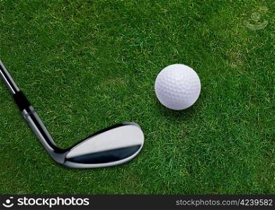 Golf ball and golf putter on green grass land .