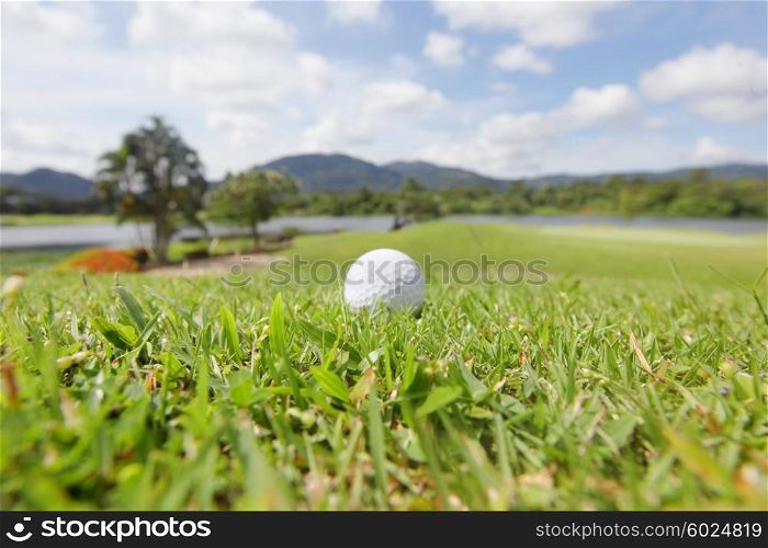 Golf ball on course. Golf ball on course with beautiful landscape on background