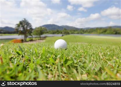 Golf ball on course. Golf ball on course with beautiful landscape on background