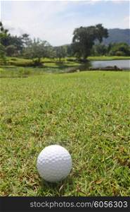 Golf ball on course . Golf ball on course with beautiful landscape on background