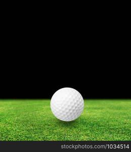 Golf ball on grass and black background