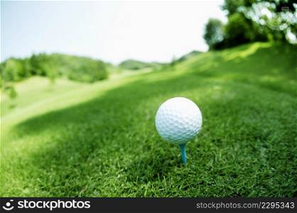 Golf ball on green field 