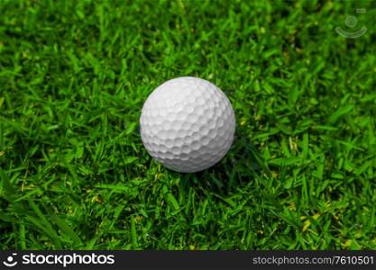 Golf ball on green grass of golf course top view. Golf ball on grass