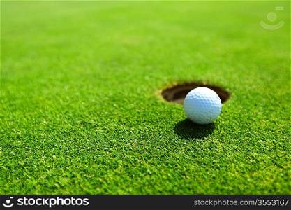 golf ball on lip of cup