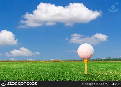 Golf ball on tee and nature background