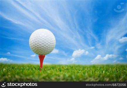 golf ball on tee with blue sky
