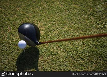golf club and ball in grass on course preparing for shot