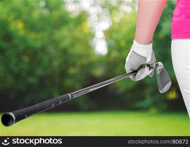 golf clubs close up in hands the athlete on a background of golf courses