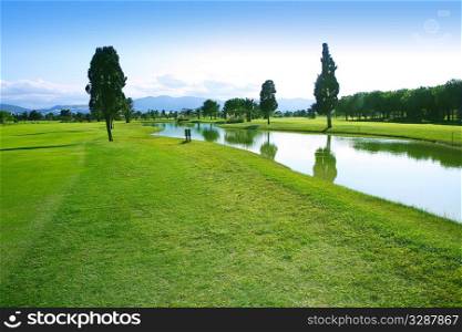 Golf course green grass field lake trees reflection