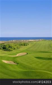 Golf course green grass, sea ocean and summer blue sky