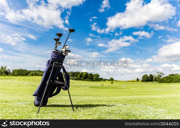 Golf equipment bag standing on a course. Summer sport and activity.. Golf equipment bag standing on a course.
