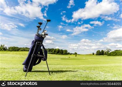Golf equipment bag standing on a course. Summer sport and activity.. Golf equipment bag standing on a course.