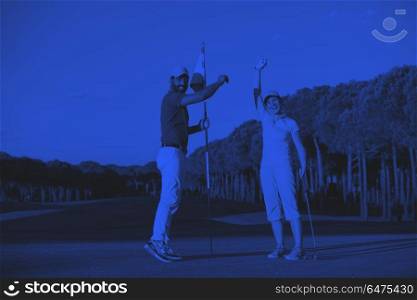golf instructions. male golf instructor teaching female golf player, personal trainer giving lesson on golf course duo tone