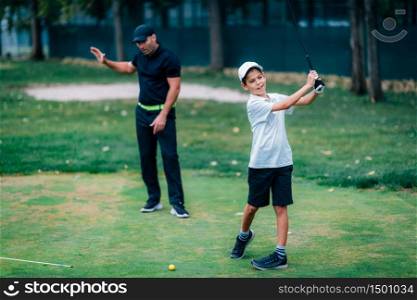 Golf ? Personal Training. Golf Instructor Teaching Young Boy How to Play Golf.