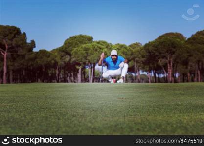 golf player aiming shot with club on course at beautiful sunny day. golf player aiming perfect shot