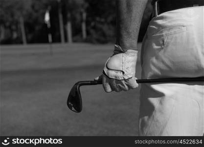 golf player hand and driver close up from back with course in background at beautiful sunny day