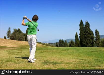 Golf Player hits his ball on the fairway