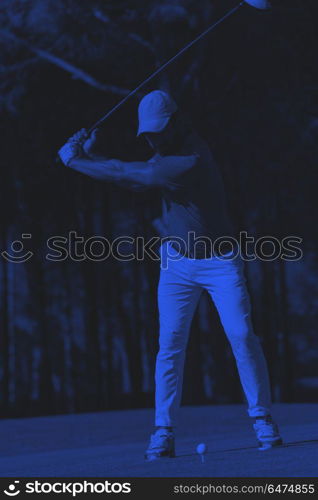 golf player hitting shot. golf player hitting shot with club on course at beautiful morning duo tone