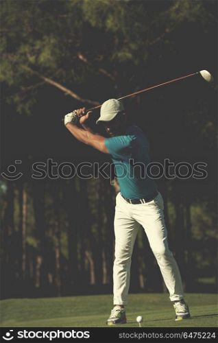 golf player hitting shot with club on course at beautiful morning. golf player hitting shot