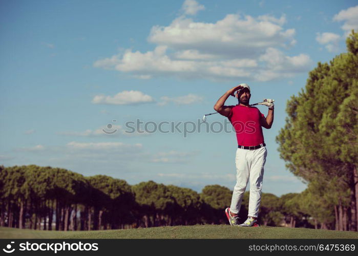 golf player hitting shot with driver on course at beautiful sunny day. golf player hitting long shot