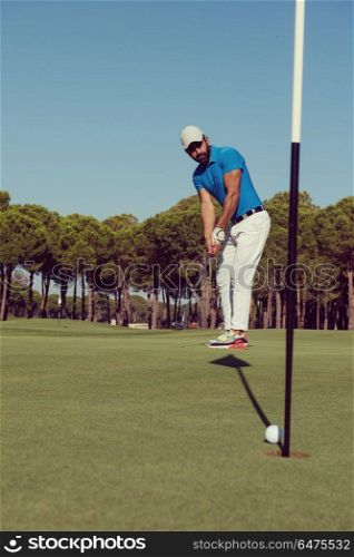golf player hitting shot with driver on course at beautiful sunny day. golf player hitting shot at sunny day