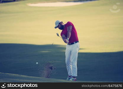 golf player hitting shot with driver on course at beautiful sunny day. golf player hitting long shot