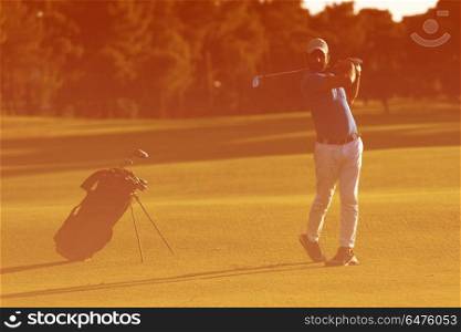 golf player hitting shot with driver on course at beautiful sunny day. golf player hitting long shot