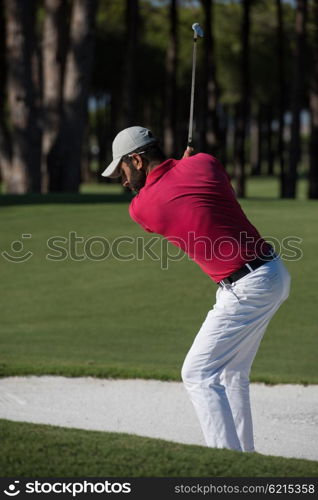 golf player shot ball from sand bunker at course