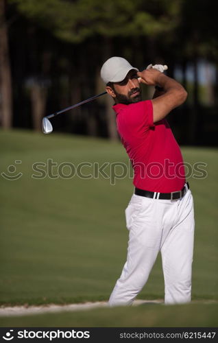 golf player shot ball from sand bunker at course