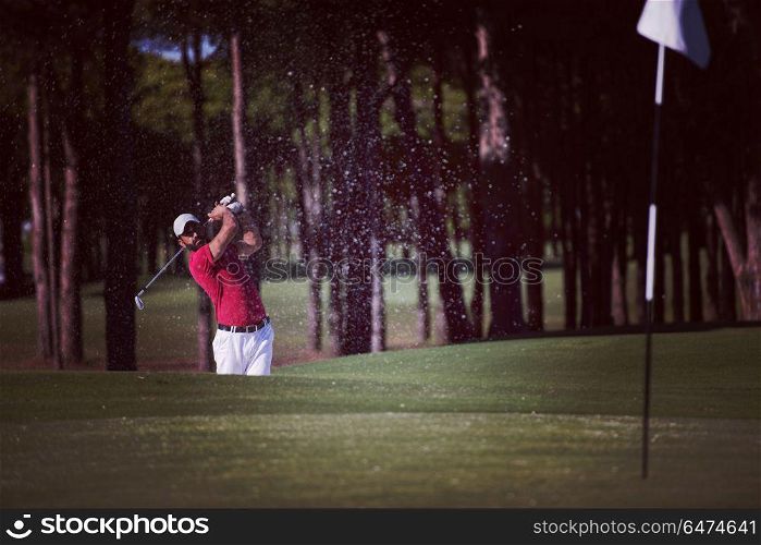 golf player shot ball from sand bunker at course. golfer hitting a sand bunker shot