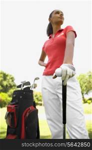 Golf player standing in golf course