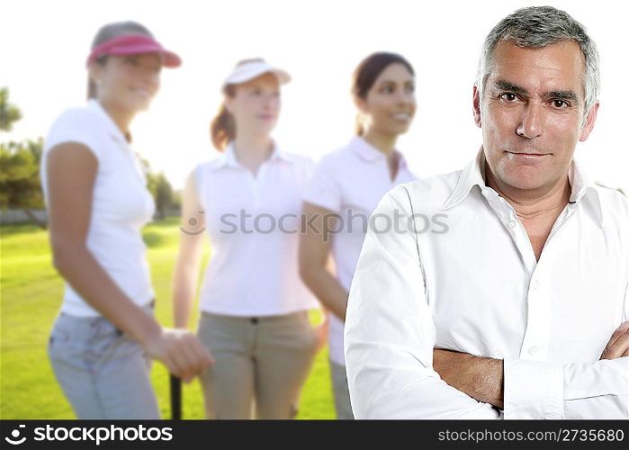Golf senior golfer man portrait in green course outdoor young three women background