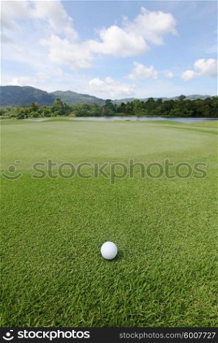 Golfball on grass . Golfball on grass of golf course at sunny day
