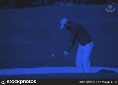 golfer hitting a sand bunker shot. golf player shot ball from sand bunker at course duo tone
